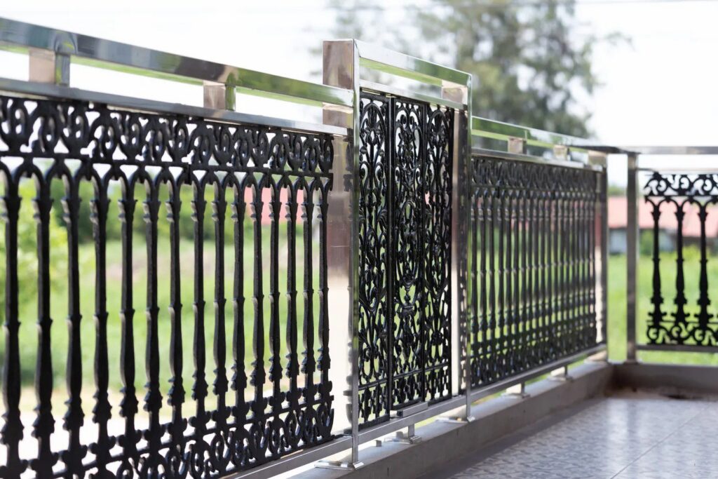 A modern black iron balcony railing with decorative panels installed by Ironcraft Welding in Chicago, IL.