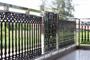 A modern black iron balcony railing with decorative panels installed by Ironcraft Welding in Chicago, IL.