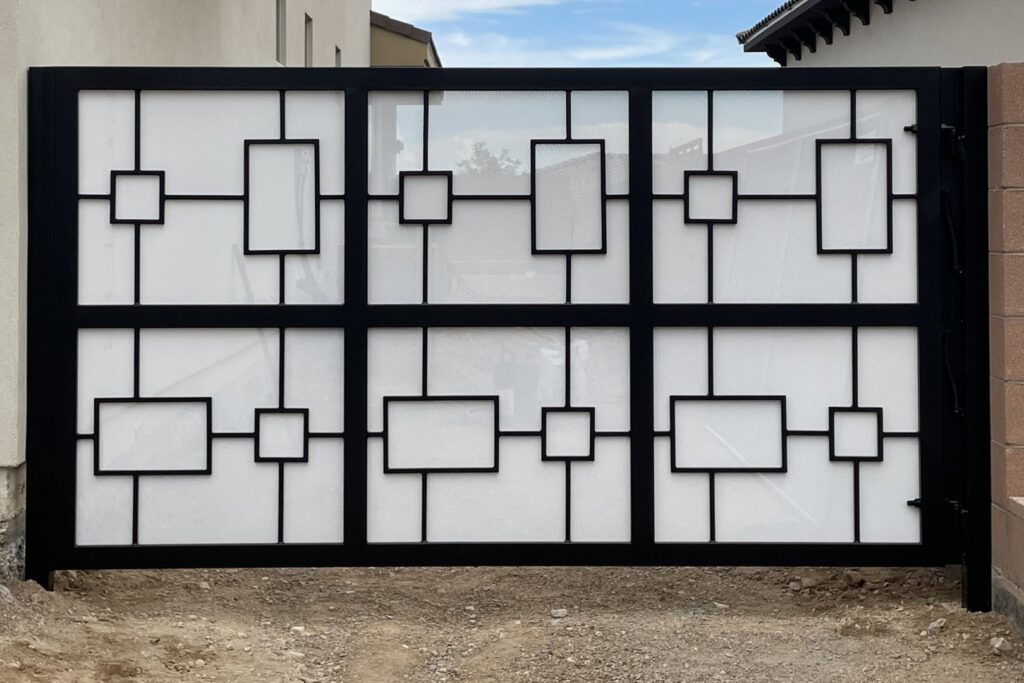 A modern black and white geometric design gate installed by Hirschi Iron, a fencing contractor in North Las Vegas, NV.