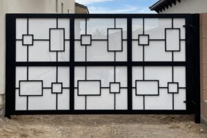 A modern black and white geometric design gate installed by Hirschi Iron, a fencing contractor in North Las Vegas, NV.