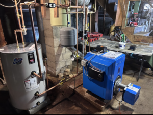 A modern blue boiler and water heater installation with new copper piping by HomeStyle Heating and Air LLC in Barrington, NH.
