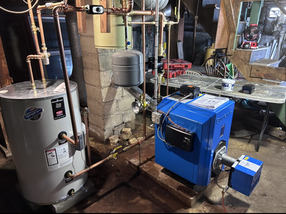 A modern blue boiler and water heater installation with new copper piping by HomeStyle Heating and Air LLC in Barrington, NH.