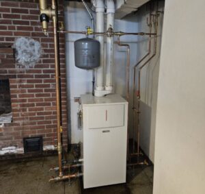 Modern white boiler system with copper piping installed by NewEra Mechanical LLC in New Britain, CT