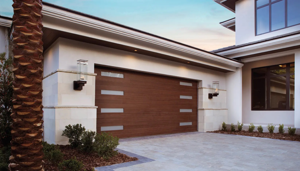 A modern brown garage door with horizontal windows on a residential home, installed by Overhead Door of New Orleans in New Orleans, LA.