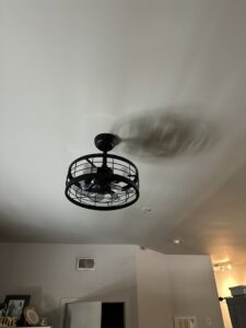 A modern black caged ceiling fan with lights installed by McCall Enterprises in Atlanta, GA.