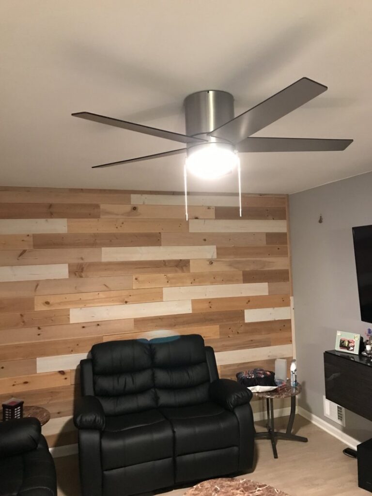 A modern ceiling fan with integrated lighting installed in a living room by MDEC Electrical & Lighting in Livonia, MI.