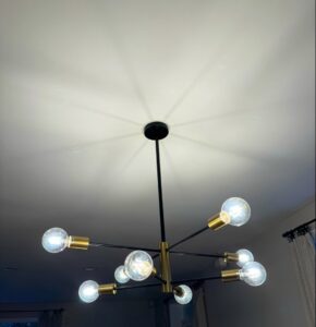 A modern chandelier with multiple bulbs installed by Electric Hero in Boston, MA