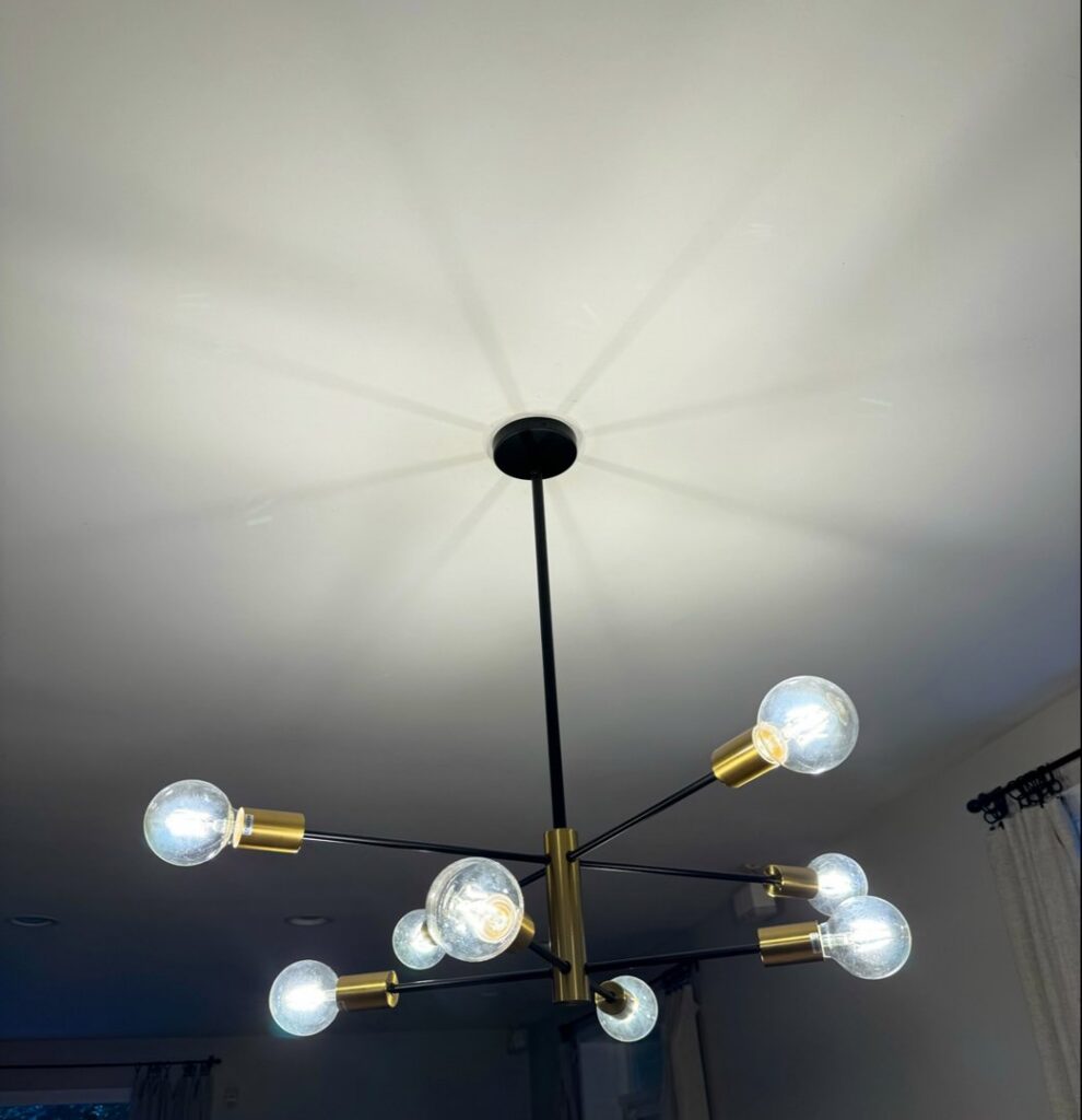 A modern chandelier with multiple bulbs installed by Electric Hero in Boston, MA