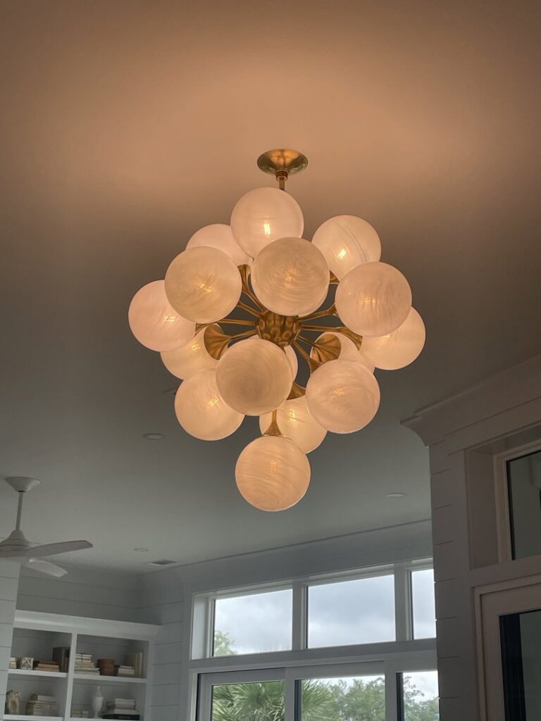 Installation of a modern chandelier in a home by OceanSide Electric in Hilton Head Island, SC.