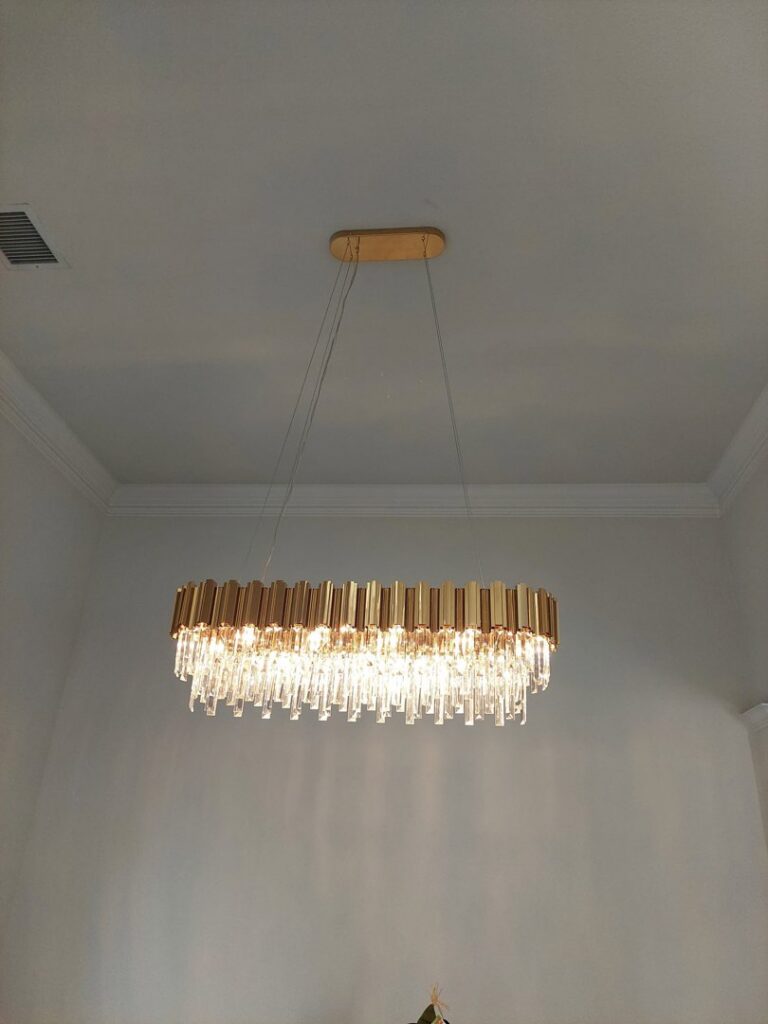 A modern rectangular chandelier light fixture installed on a ceiling by Tesla Alarm and Electrical in Plano, TX