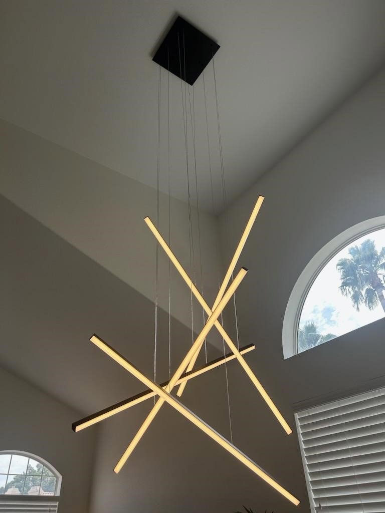 Modern linear chandelier installed in a high ceiling by Turn It On Electric in Phoenix, AZ