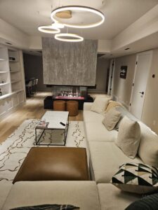 Modern ring chandeliers providing ambient lighting in a living room, installed by All Aboard Services in Farr West, UT.