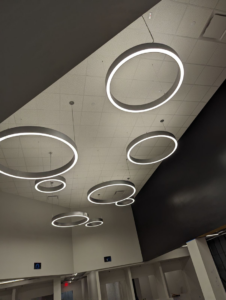 Modern circular light fixtures professionally installed on a ceiling, showcasing lighting services by Zuz Electric in Houston, TX.