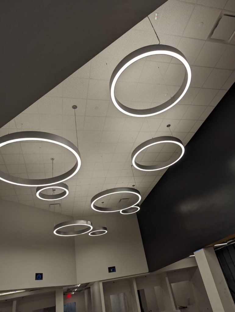 Modern circular light fixtures professionally installed on a ceiling, showcasing lighting services by Zuz Electric in Houston, TX.