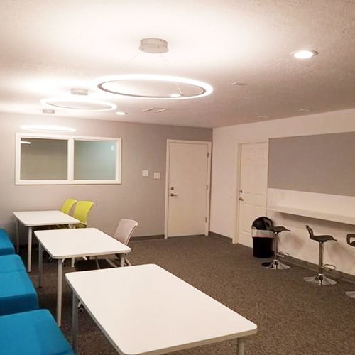 Room with modern circular and recessed lighting installed by True Light Electric in Albuquerque, NM.