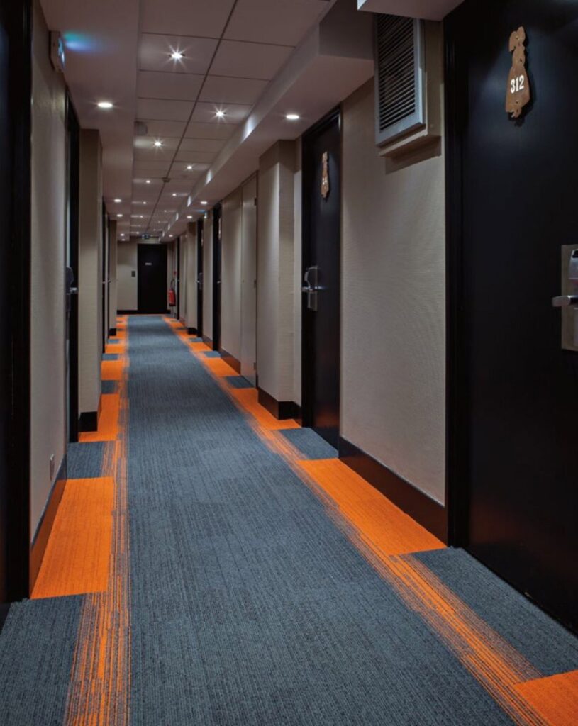 A newly installed modern commercial carpet in a hallway, showcasing work by Jay Dee Inc. in Denver, CO.