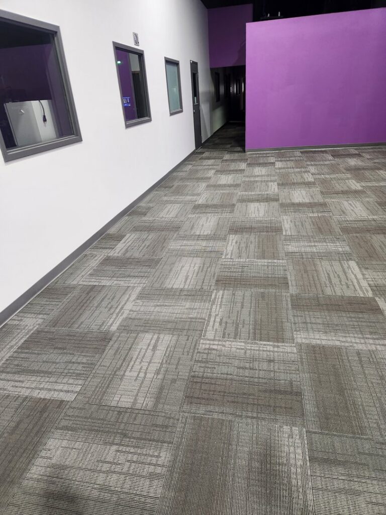 Modern patterned carpet tiles installed in a commercial hallway by Great Spaces Floor Co in Minneapolis, MN.