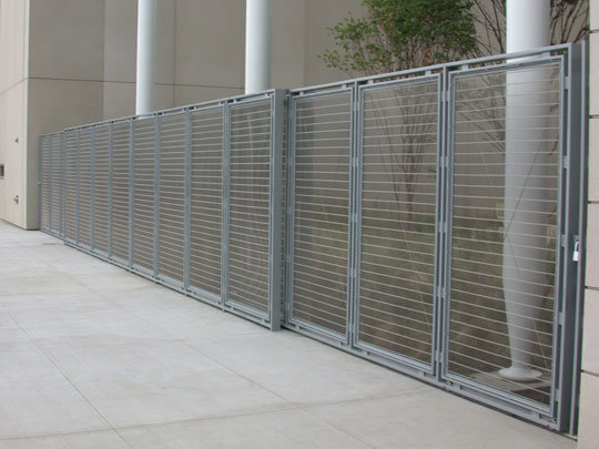 A modern commercial metal fence with horizontal slats installed by Superior Custom Fence Inc. in Chicago, IL.