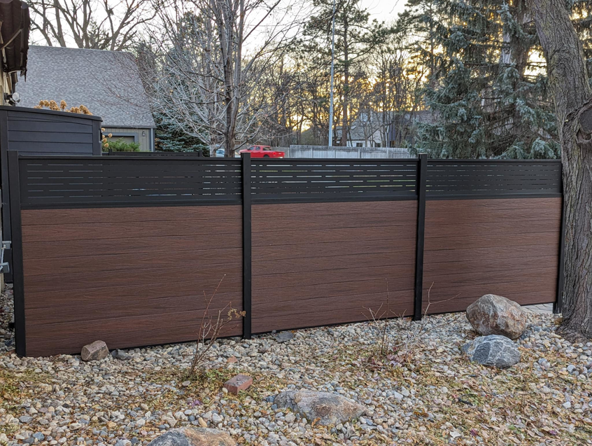 Modern composite privacy fence with dark brown panels installed by Solid Fence Co. in Sioux Falls, SD.