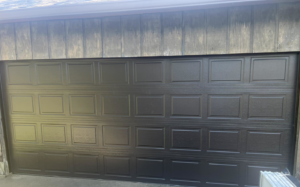 A modern dark panel garage door installed by Taylor Overhead Door Co. in Dallas, TX