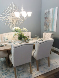 A modern dining room featuring a light-colored area rug, provided and installed by Dallas Rugs in Dallas, TX.