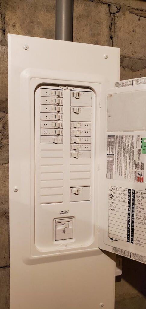 A modern electrical breaker panel with the door open, revealing neatly arranged circuit breakers, installed by Devaney Electric Co. in Lacey, WA.