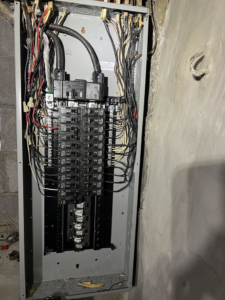 A modern electrical breaker panel with neatly organized wiring, installed by KNK Electric in Pittsburgh, PA.