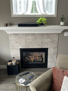 A modern fireplace with a gas insert and decorative logs, installed by Spartan Heating, Cooling and Fireplaces in Cedar Rapids, IA
