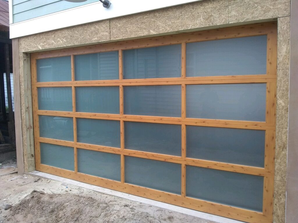 A modern garage door with frosted glass panels and a wooden frame, installed by Precision Garage Door of Charleston in North Charleston, SC.