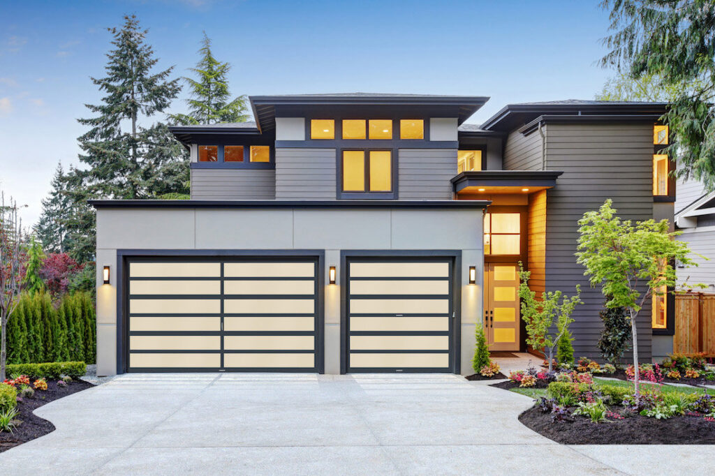 Two modern garage doors with frosted panels on a stylish home by American Overhead Door in Madison, AL