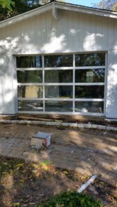 A modern full-view glass garage door installed by Garage Door Specialists Of Oklahoma Inc. in Oklahoma City, OK