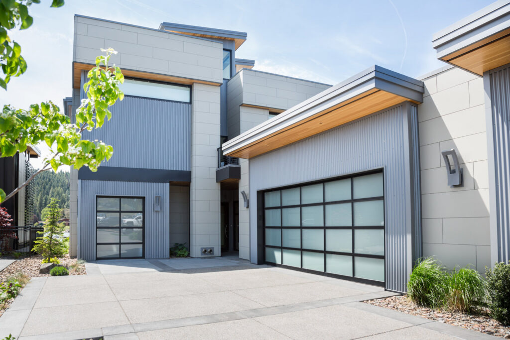 Modern full-view glass garage doors on a contemporary home, installed by Continental Door Company in Spokane Valley, WA.