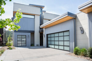Modern full-view glass garage doors on a contemporary home, installed by Continental Door Company in Spokane Valley, WA.