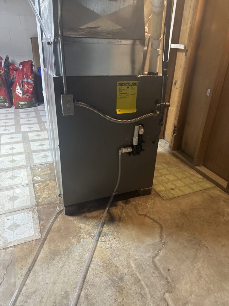 A modern furnace unit with an EnergyGuide label installed in a basement by Done Right Air in West Allis, WI