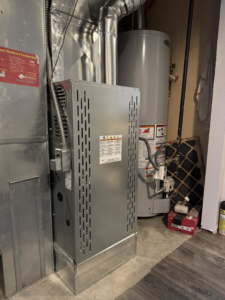 A modern furnace and water heater setup in a utility space, installed by Nexus Heating & Air in Denver, CO.
