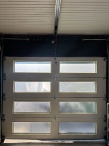 A stylish modern garage door with frosted glass panels, installed by Lenny's Garage Door in Louisville, KY.