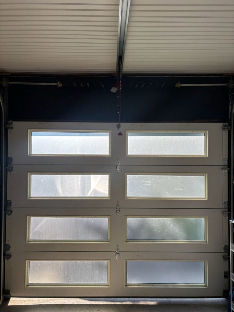 A stylish modern garage door with frosted glass panels, installed by Lenny's Garage Door in Louisville, KY.