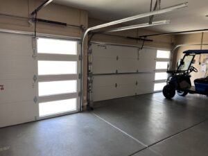 Interior view of a garage with newly installed modern garage doors by Iconic Garage Door Service in Queen Creek, AZ.
