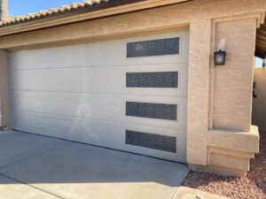 A newly installed modern garage door with windows by Nate's Garage Door Repair in Scottsdale, AZ.