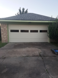A modern light-colored garage door with multiple windows installed by Residential WorX LLC in Westlake, LA.