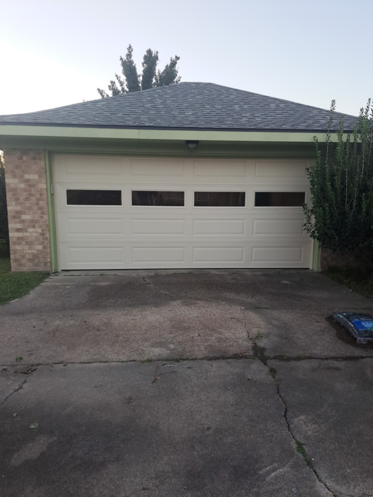 A modern light-colored garage door with multiple windows installed by Residential WorX LLC in Westlake, LA.