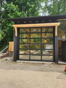 A modern glass garage door with black frames installed by Overhead Door Company of Everett, Inc in Everett, WA.