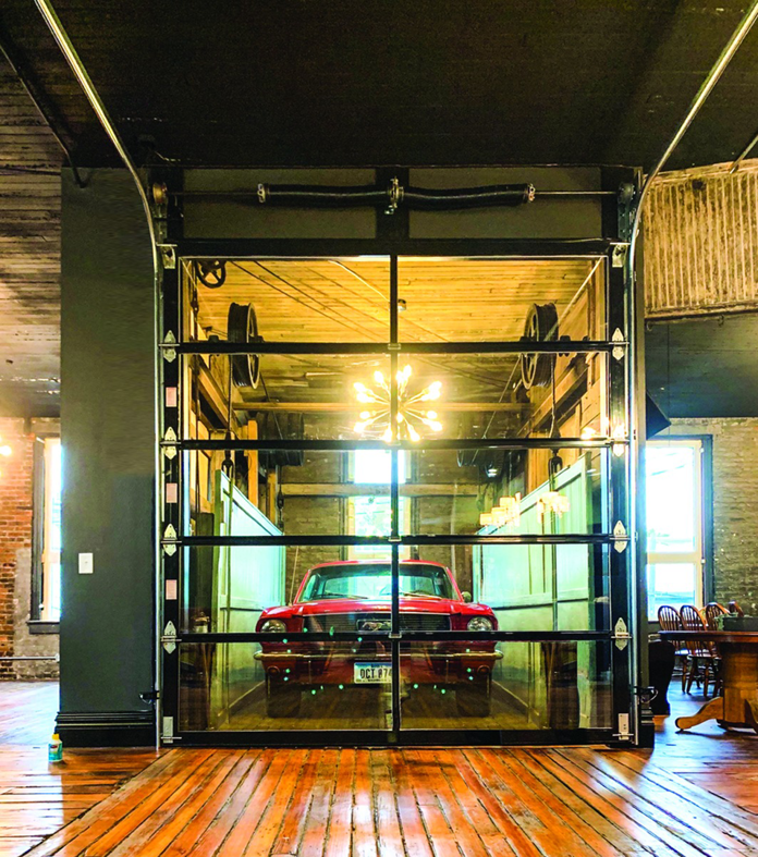Modern glass garage door installed in a commercial space by Overhead Door Company of the Great Plains in Lawton, OK.