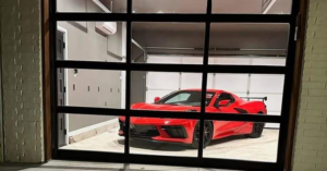 A modern glass garage door with black frames installed by Entry Garage Door in Shawnee, OK.