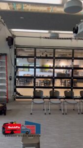 A modern glass garage door installed as an interior partition by QuickFix Garage Door Service in Brighton, MA.