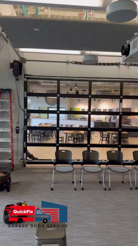 A modern glass garage door installed as an interior partition by QuickFix Garage Door Service in Brighton, MA.