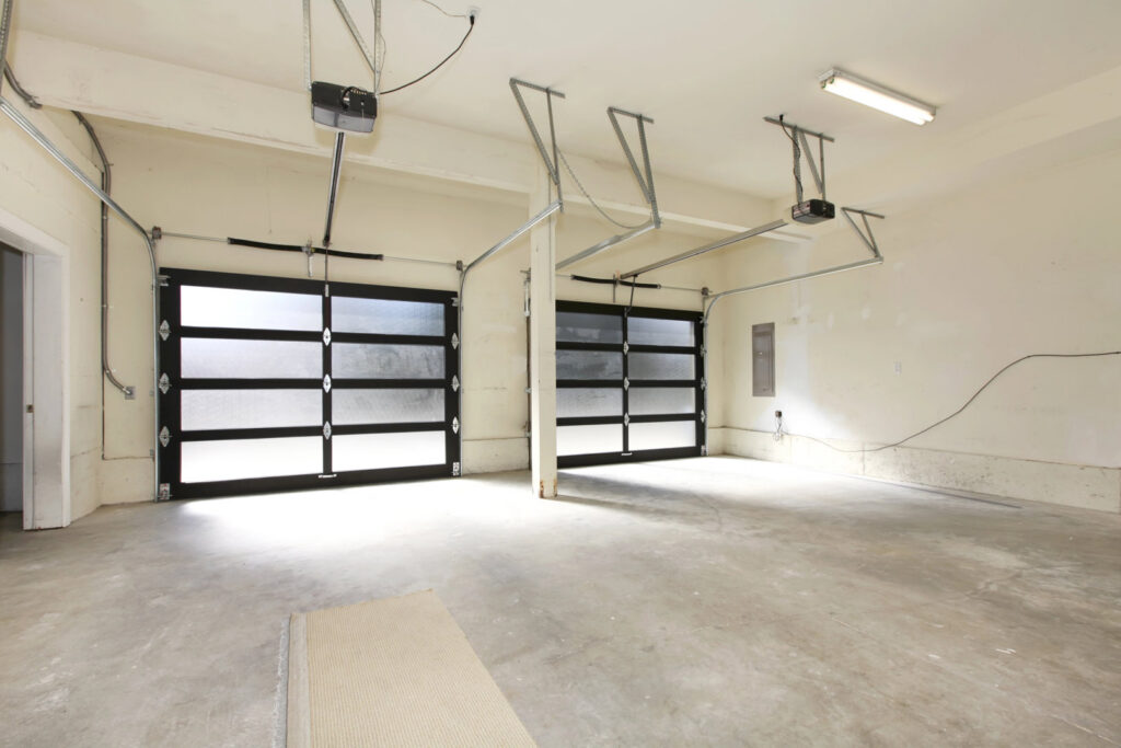 Interior view of modern black and frosted glass garage doors with openers installed by BSD Garage Door in Naperville, IL
