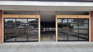 Two modern glass garage doors installed on a commercial building by Ken's Overhead Door in Clarksville, TN.