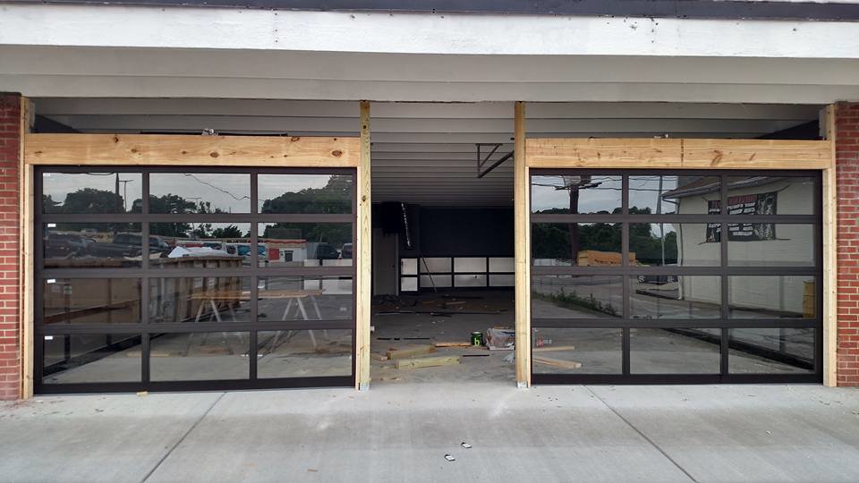 Two modern glass garage doors installed on a commercial building by Ken's Overhead Door in Clarksville, TN.