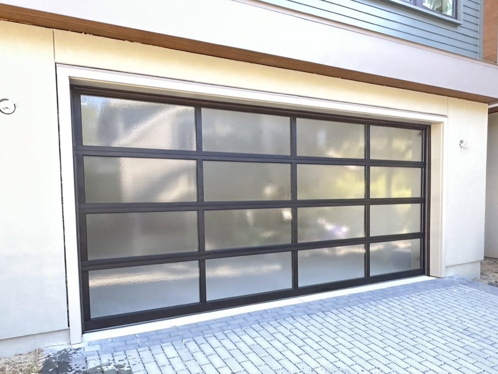 A modern glass panel garage door installed by On Track Garage Doors in Charleston, SC.